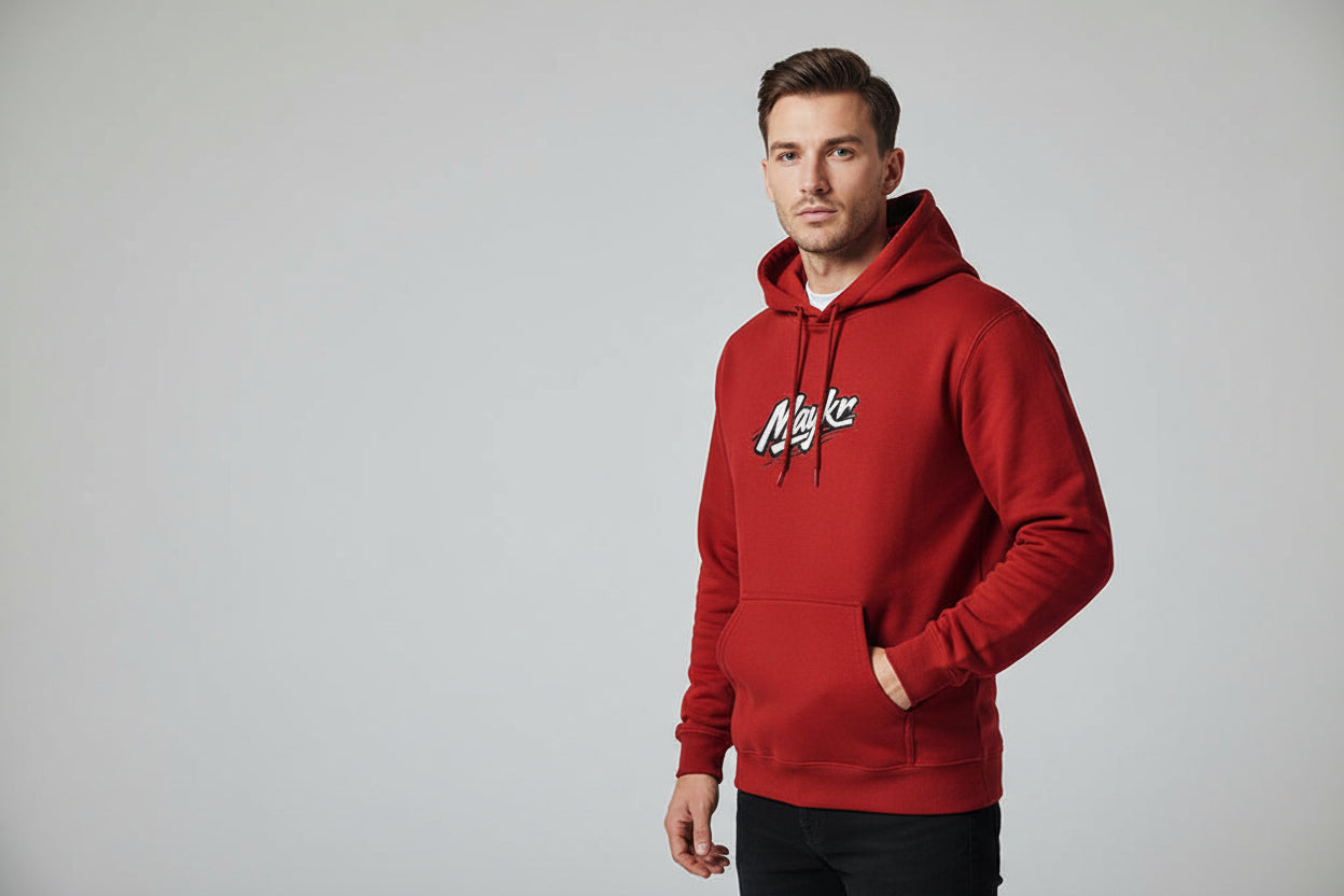 Man wearing red MAYKR Classic Trend Hoodie; heavyweight 300 GSM brushed fleece, unisex regular fit, front pocket.
