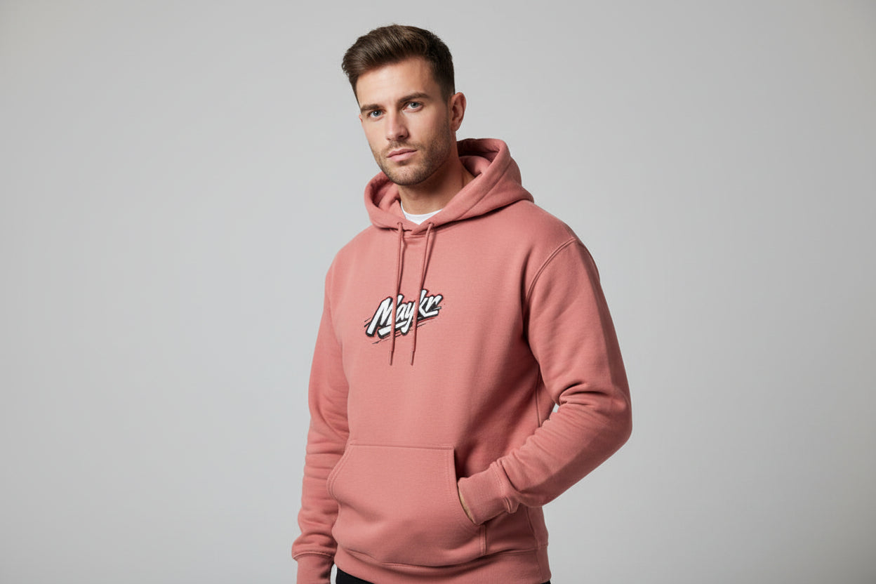 Male model wearing MAYKR Classic Trend Hoodie in dusty rose, unisex regular fit with 300 GSM brushed fleece.
